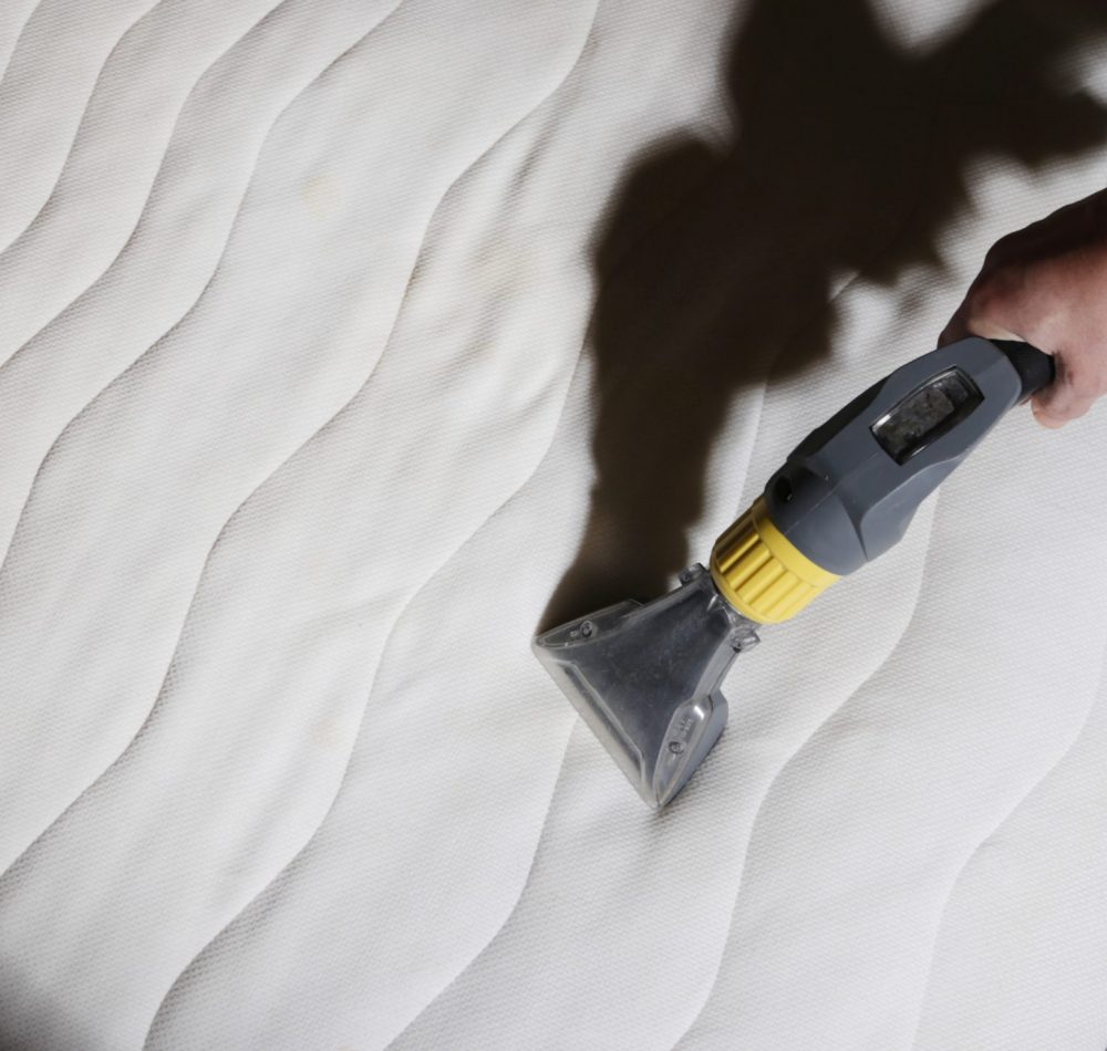 woman-cleaning-mattress-with-vacuum-washing-cleane-2021-12-09-19-27-41-utc